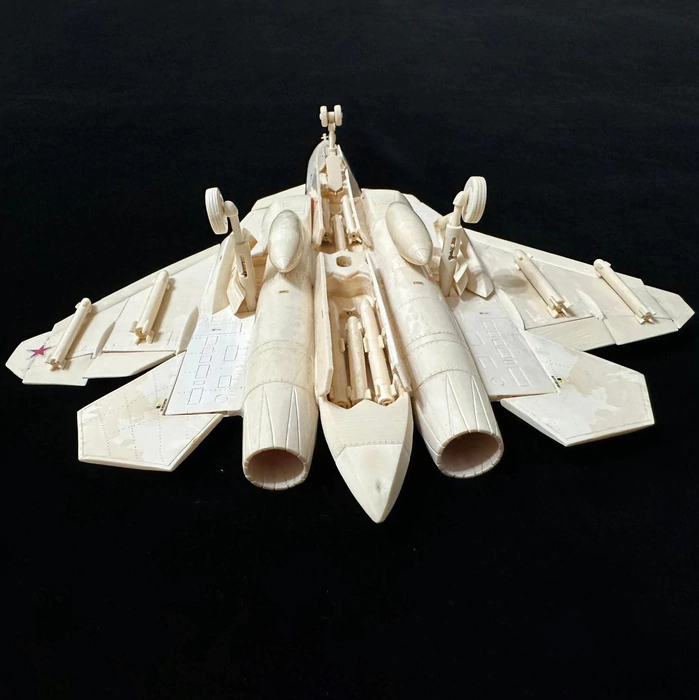 A composite model of the SU-57 mammoth tusk aircraft on a stand